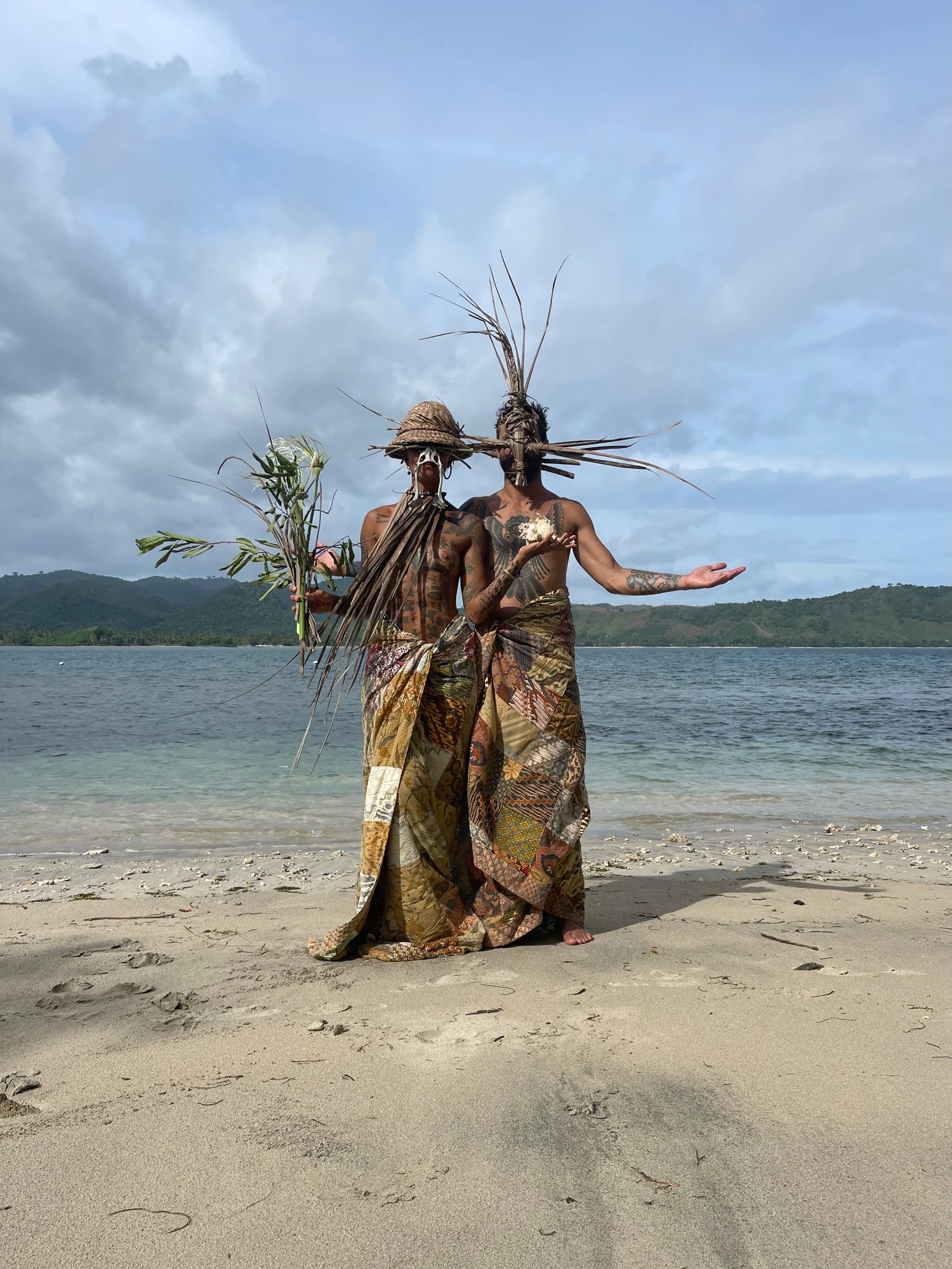 André and Fa' in ceremonial dress on the beach of Gili Asahan